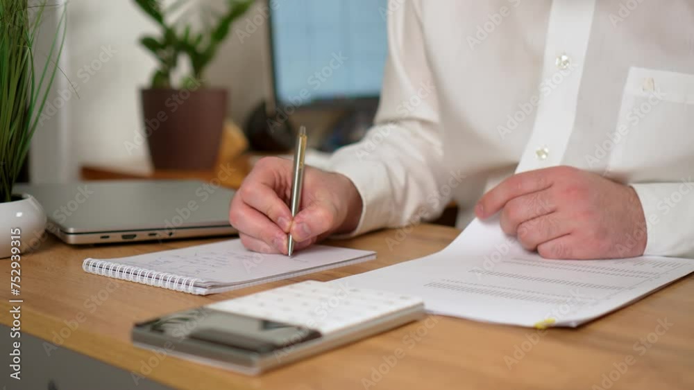 Businessman hand calculating monthly expenses calculator close up. Debt and payment concept background. Male professional working at office workplace Businessman hand calculating monthly expenses calculator close up. Debt and payment concept background. Male professional working at office workplace