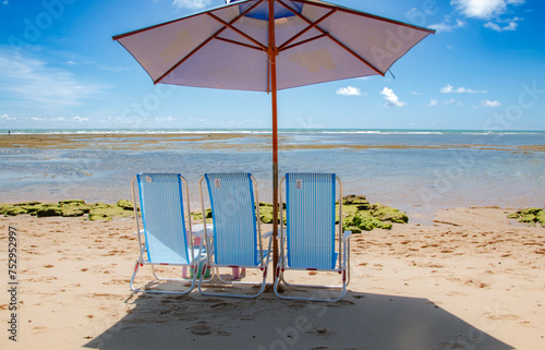 chairs with umbrella on the beach in beautiful summer day and blue sky