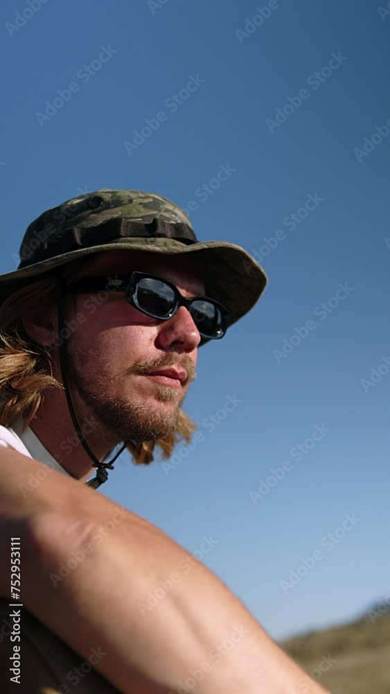 In the crisp mountain air, a traveler in functional streetwear takes a moment for themselves, sipping coffee with a backdrop of clear blue skies. Their relaxed posture and the practicality of their In the crisp mountain air, a traveler in functional streetwear takes a moment for themselves, sipping coffee with a backdrop of clear blue skies. Their relaxed posture and the practicality of their