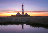Lighthouse Westerhever at sunrise with reflections