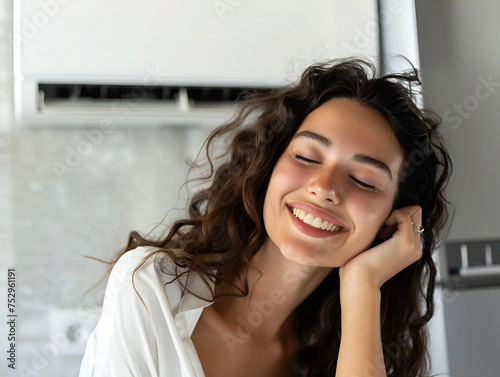 A woman enjoys the cool air conditioning, embodying the essence of relaxation and contentment.
