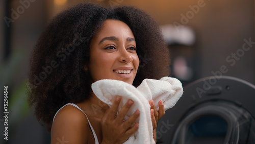 African American girl ethnic lady biracial woman housewife home work routine good smell laundry clothes open washing machine housekeeping household housework smelling clean cloth aroma conditioner photo