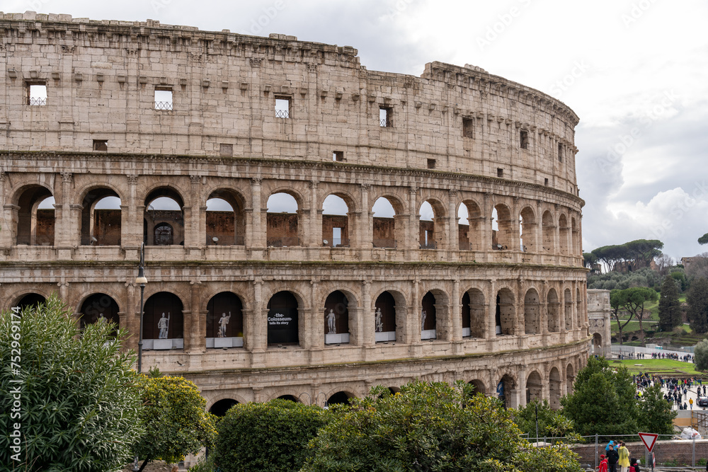 The Colosseum is a large, ancient building with arched windows