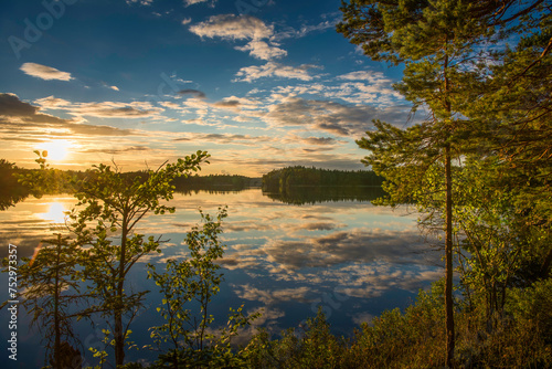 Fototapeta Naklejka Na Ścianę i Meble -  sunset over lake in Sweden framed by trees