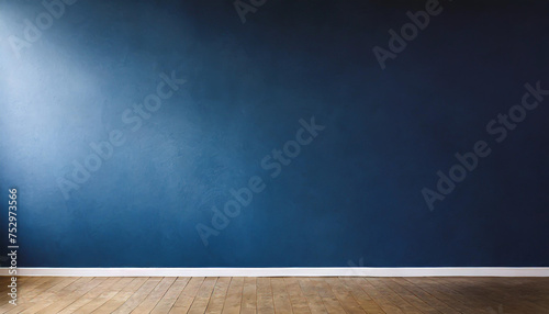 Dark blue wall in an empty room with a wooden floor