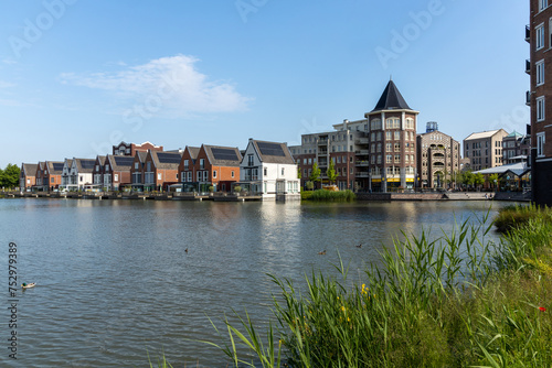 Utrecht  the Netherlands. 5 June 2023. Center Vleuterweide Utrecht with shops and houses equipped with solar panels. with a lake in front