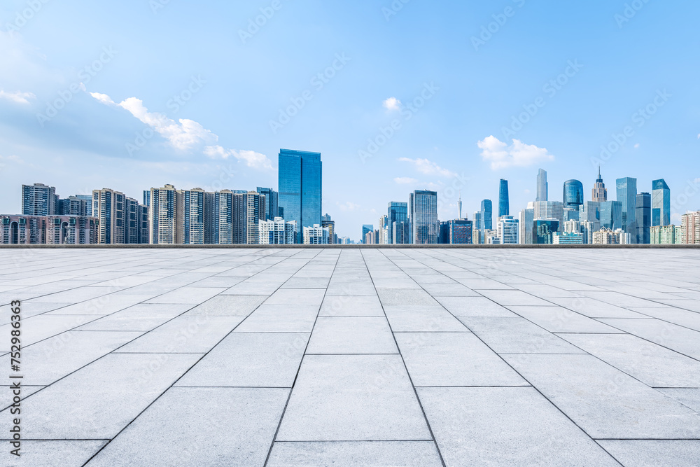 Empty square pavement and city skyline background