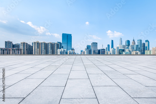 Empty square pavement and city skyline background