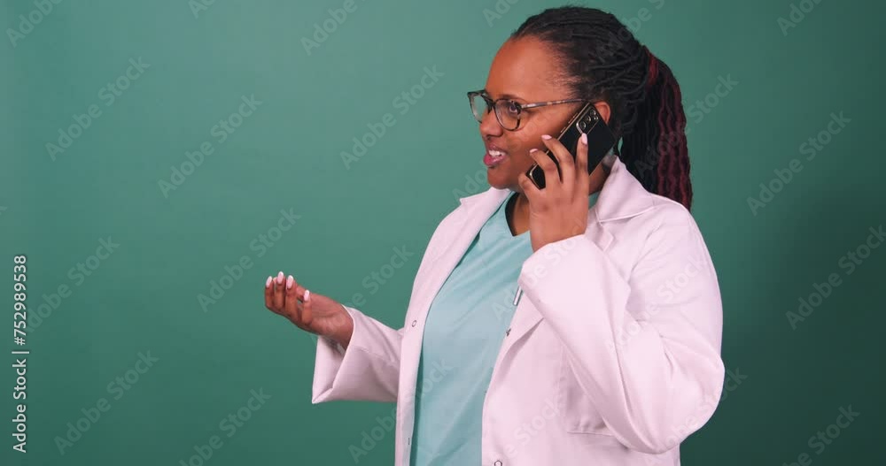 Busy Black female doctor answers cellphone, gestures while talking copy space Busy Black female doctor answers cellphone, gestures while talking copy space
