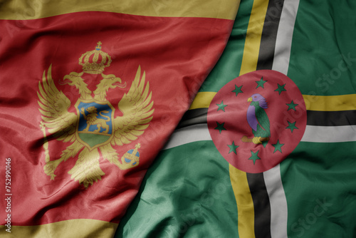 big waving national colorful flag of dominica and national flag of montenegro .