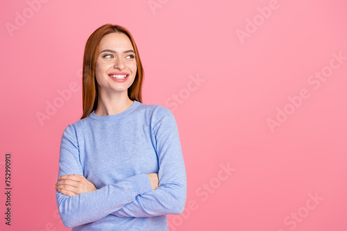 Photo of toothy beaming adorable woman dressed blue shirt look at offer empty space arms crossed isolated on pink color background