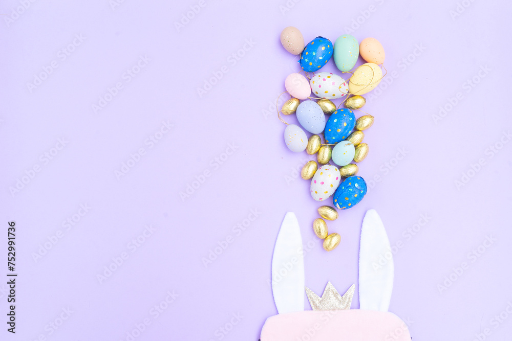 Easter scene with colored eggs and rabbit's ears, copy space Easter scene with colored eggs and rabbit's ears, copy space