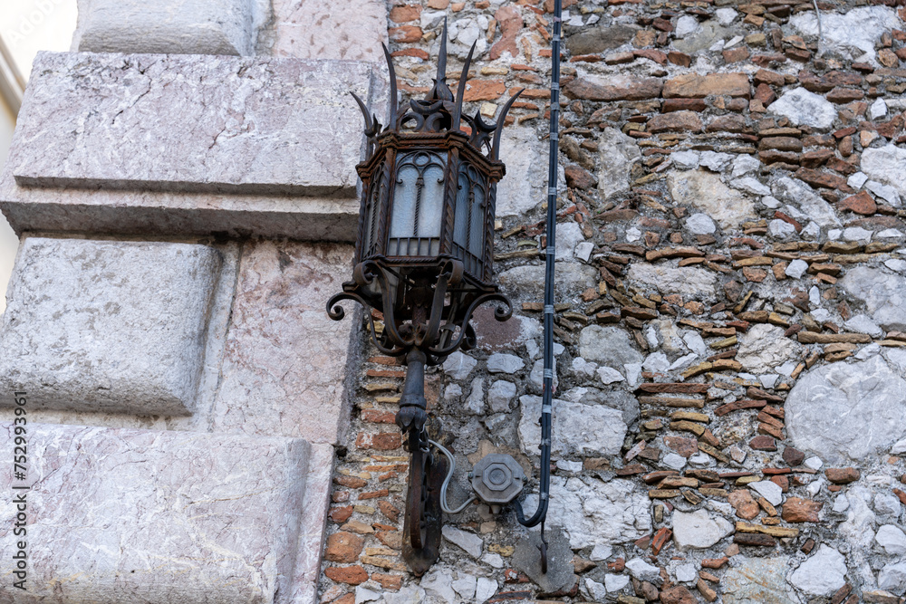 A lamp hanging from a stone wall