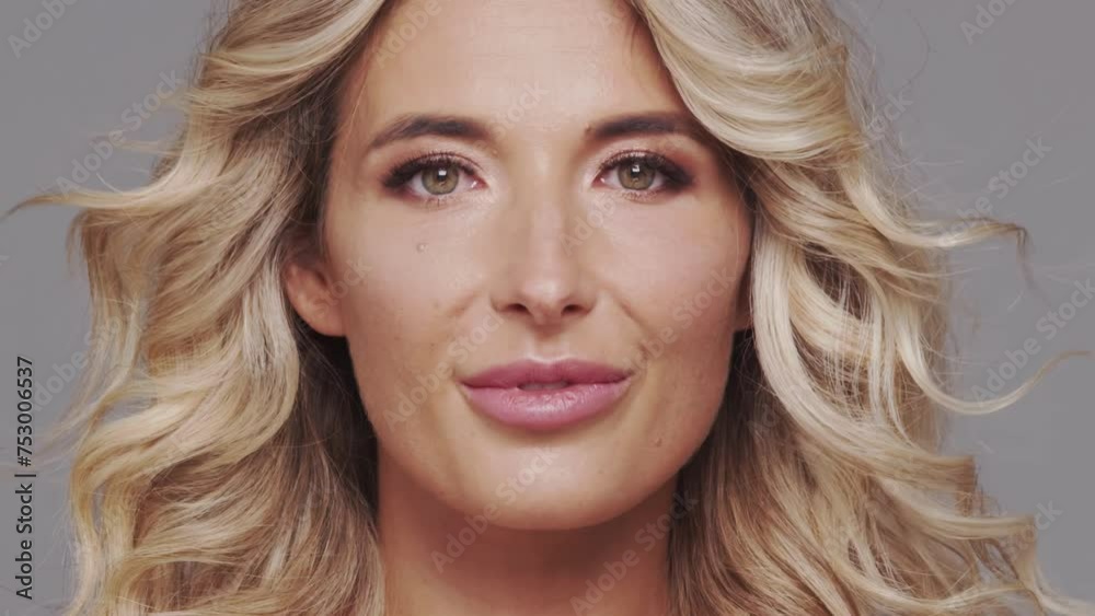 Studio portrait of young and beautiful blond woman over grey background. Skin care and wellness concepts. Studio portrait of young and beautiful blond woman over grey background. Skin care and wellness concepts.