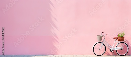 Vintage White Bicycle Leaning on Pink Wall in Urban Setting photo
