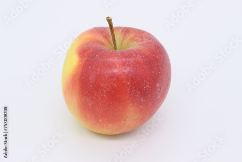 A very appetizing red apple is depicted on a light background.