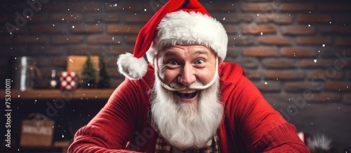Cheerful Man in Santa Claus Hat Pulls Funny Face to Spread Festive Joy and Laughter photo