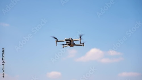 Drone copter with a digital camera flies to take high-angle photos.