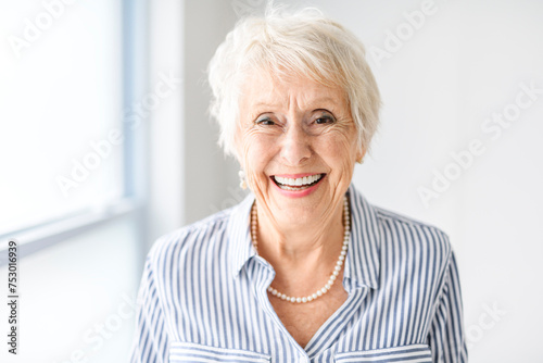 senior lady posing at home portrait close to a window