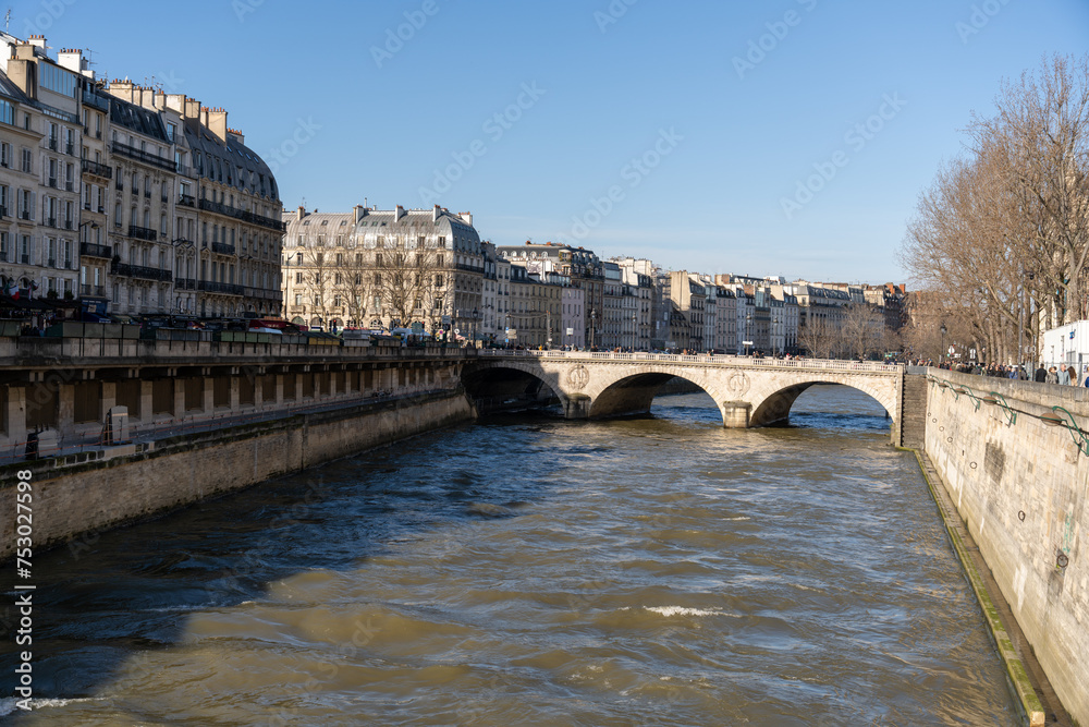 A river runs through a city with a bridge over it