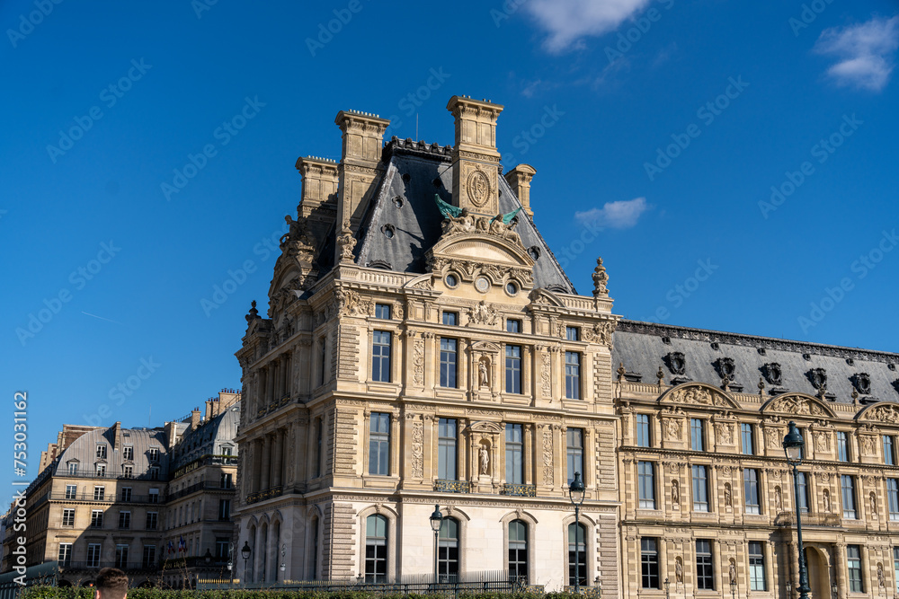 A large building with a lot of windows and a blue sky in the background