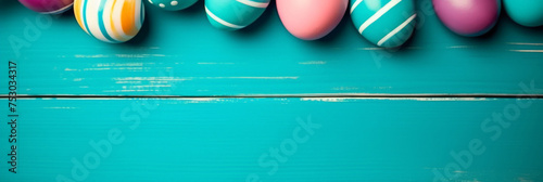 colorful painted easter eggs on blue  wood background. Easter frame of eggs painted in blue red yellow pink green colorful color. Flat lay, top view. Copy space for tex photo