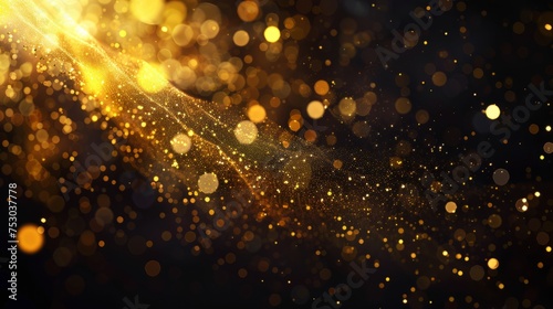Defocused golden yellow color flecks and bokeh on dark black abstract background 