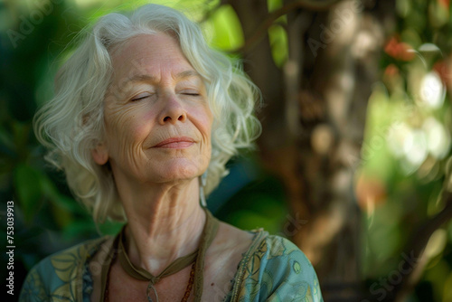Photo of a senior woman meditating in a peaceful garden, with a close-up on her serene face and the natural surroundings, representing mental and physical harmony