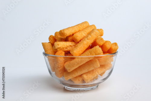 Stik Balado, crackers with savory powder coating. In transparent glass bowl. Isolated on white background
