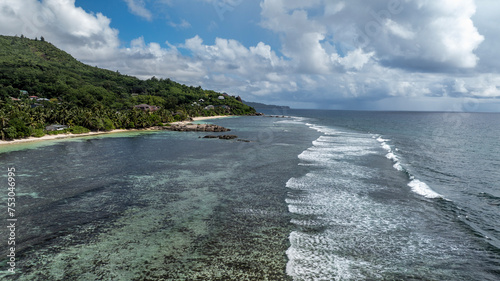 panoramic view from a drone of the sea bays and beaches on a sunny day of the Seychelles islands