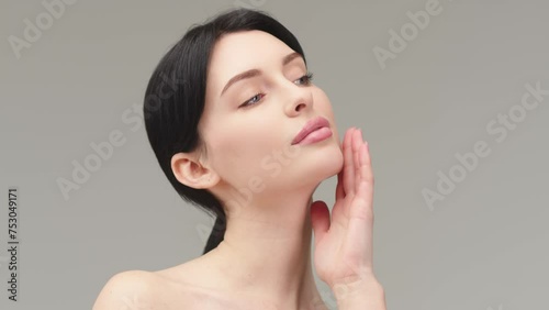 Portrait of a young woman isolated on a light background. Skin care. Beautiful female model with perfectly clean fresh skin. Natural beauty and cosmetology concept