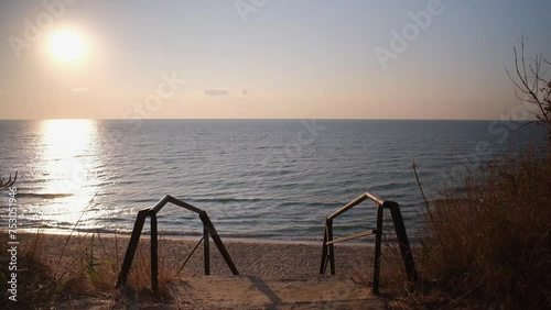 Metal staircase with handrails leading to the beach. Beautiful view of the Black Sea. Resort. Ukraine. photo