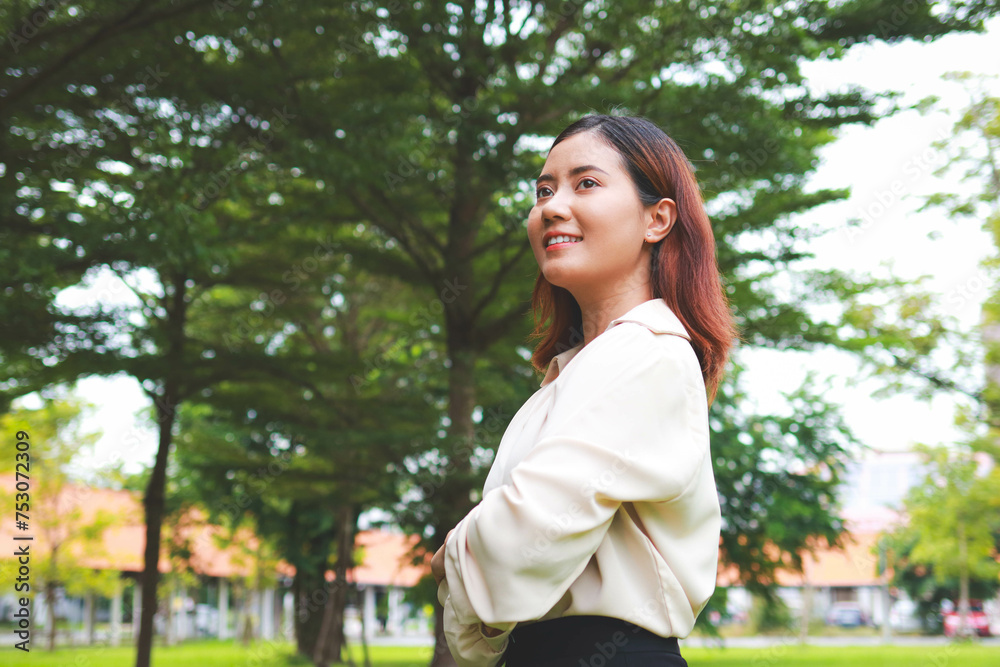 Portrait of a happy Asian woman smiling in an outdoor garden. health insurance, health care. copy space Portrait of a happy Asian woman smiling in an outdoor garden. health insurance, health care. copy space