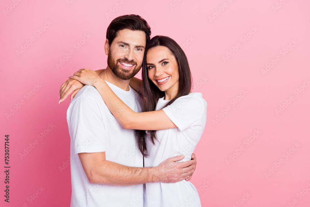 Photo portrait of lovely young couple hugging love each other dressed stylish white garment isolated on pink color background Photo portrait of lovely young couple hugging love each other dressed stylish white garment isolated on pink color background