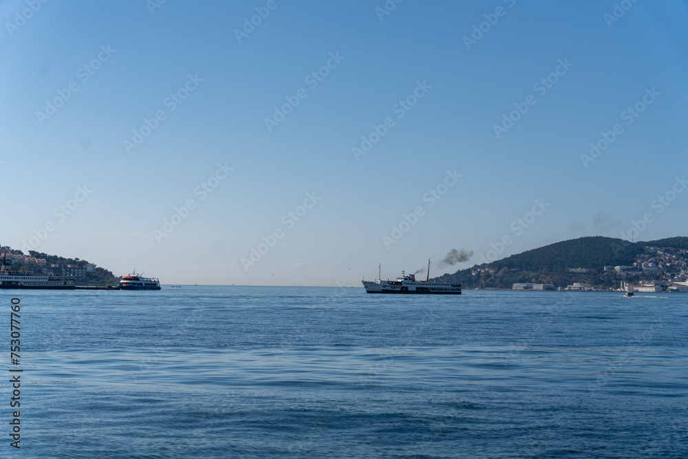 A large ship is sailing in the ocean next to a smaller ship