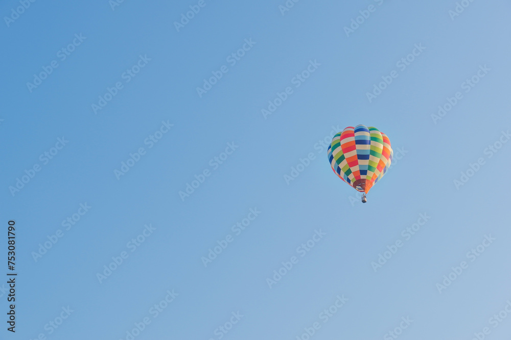 Hot air balloons landing in a mountain flight over field and forest,colorful Hot air balloons flying over the valley with blue sky,Tourism concept.