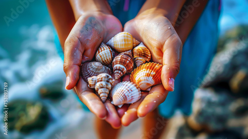Hands Full of Assorted Colourful Seashells. Close-up of hands holding a variety of colourful shells. 
