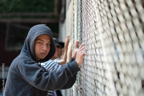Photos Detention of teenboy inside detention center, bad behavior, humans freedom and humans rights concept, soft focus