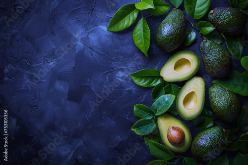 Ripe avocado fruits and leaves on a dark slate gray background. vegan food banner  with top view and a big space for text or product. photo