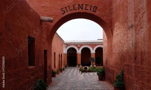 Beautiful courtyard for silence and calm practice with colorful red walls  and arches in the Monastery of Saint Catherine, Arequipa, Peru