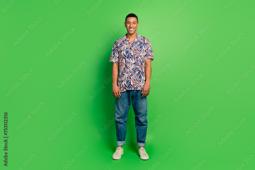 Full length photo of attractive cheerful man standing in stylish collection outfit isolated on green color background Full length photo of attractive cheerful man standing in stylish collection outfit isolated on green color background