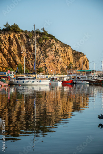 Small boats docked on the marina park with oceanfront view.