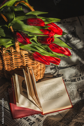 Red tulips in the busket and the book