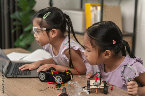 Asian littlle girl constructing and coding robot at STEM class,Fixing and repair mechanic toy car