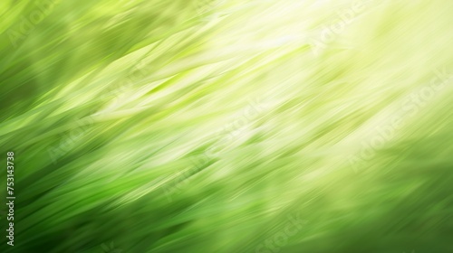 Motion-blurred abstract background in green colors on a smooth texture. Colorful background blurred by speed in light green areas.