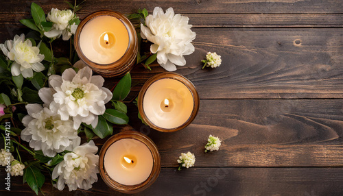 Top view scene burning candle and flowers on wooden background, copy space, beautiful home interior
