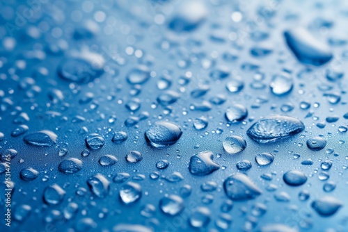 Smooth surface with water droplets on blue background.