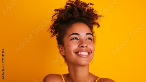 Model with raising one eyebrow with a big smile, thinking something, minimal yellow background.