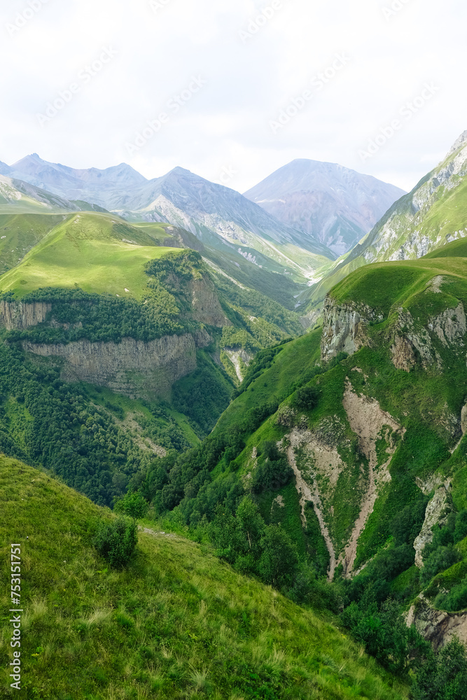 Naklejka premium landscape with grass and clouds in the caucasus mountains