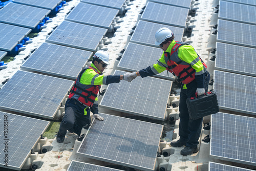 Wallpaper Mural Photovoltaic engineers work on floating photovoltaics. workers Inspect and repair the solar panel equipment floating on water. Engineer working setup Floating solar panels Platform system on the lake. Torontodigital.ca